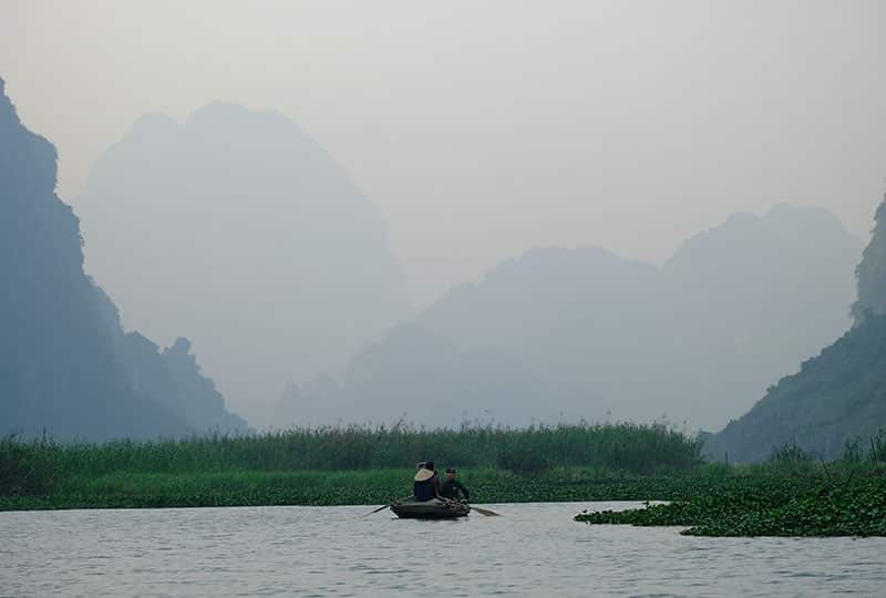 a boat on the river with mountains