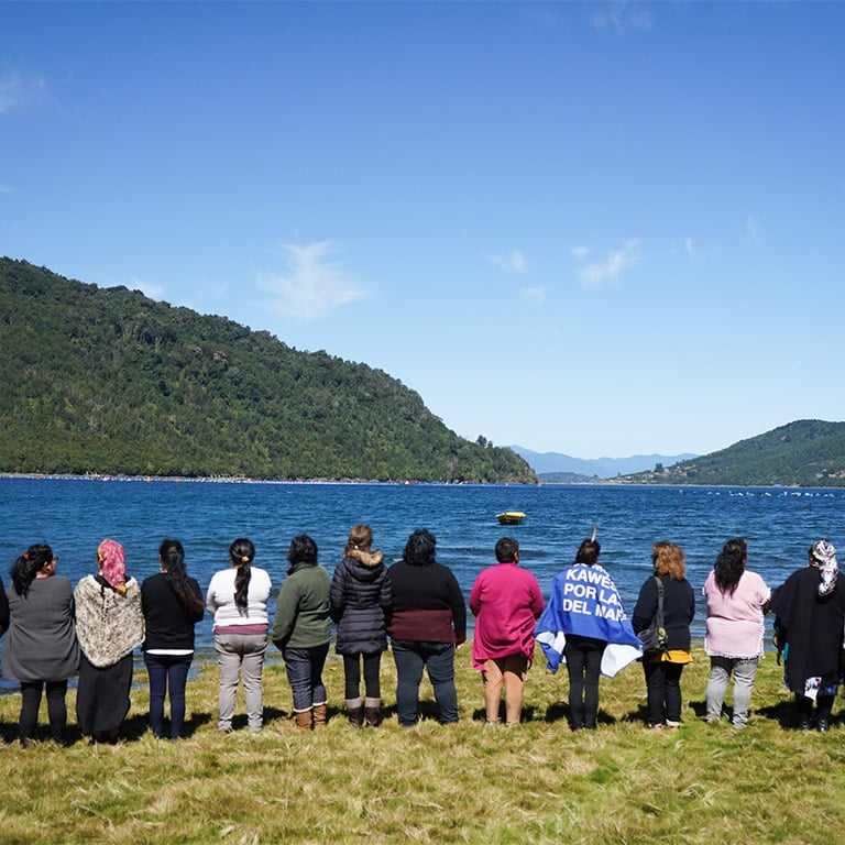 Women facing river or estuary