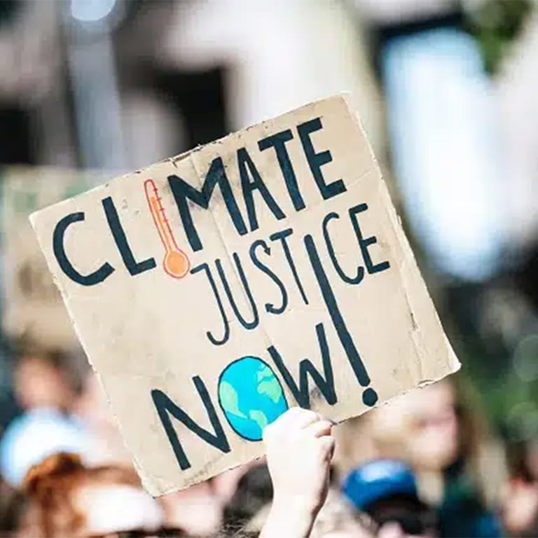 Protest sign reading 'Climate justice now!'