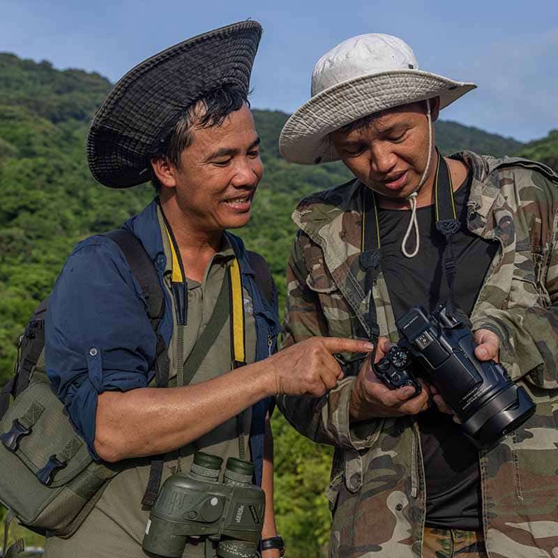 Two men looking at a picture on a camera