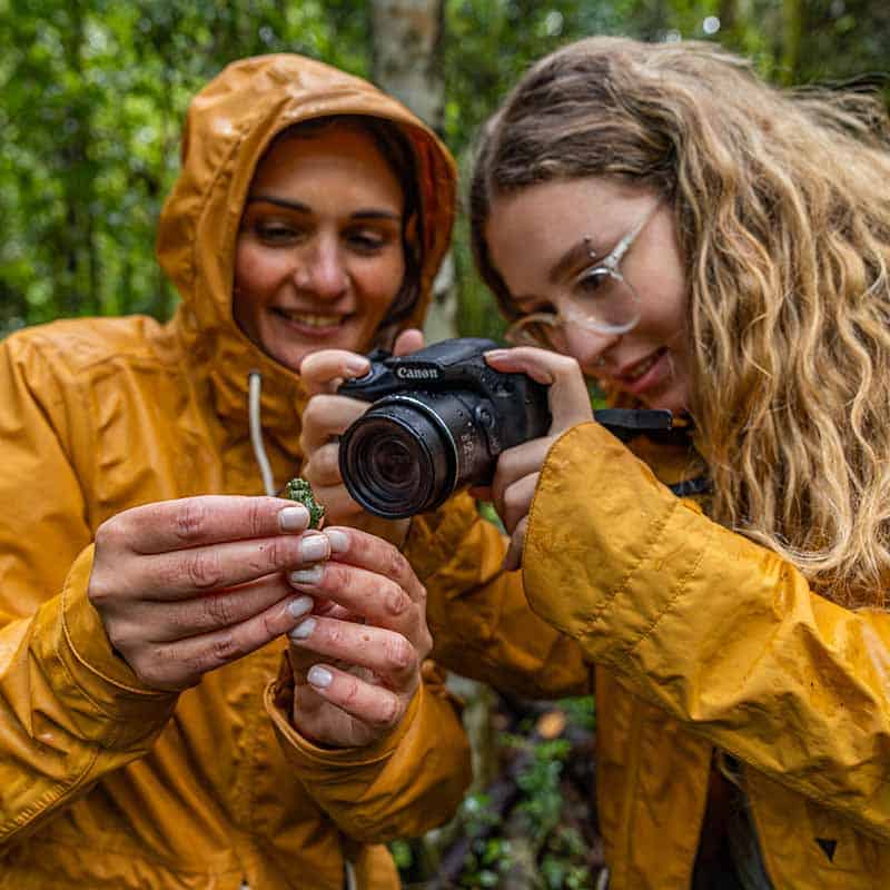 two women looking at a picture on a camera together