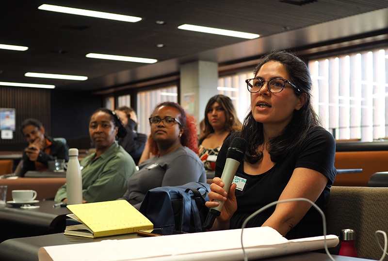 Participant asking a question in audience of RACE Summit