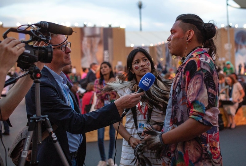 Two young Indigenous people speaking to the media