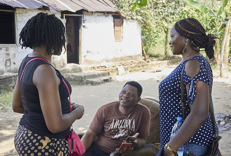 Two women speaking to a man