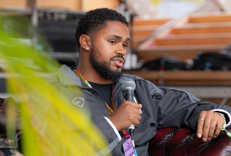 Person talking into a microphone at an event