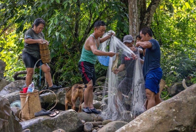 Five people holding a fishing net